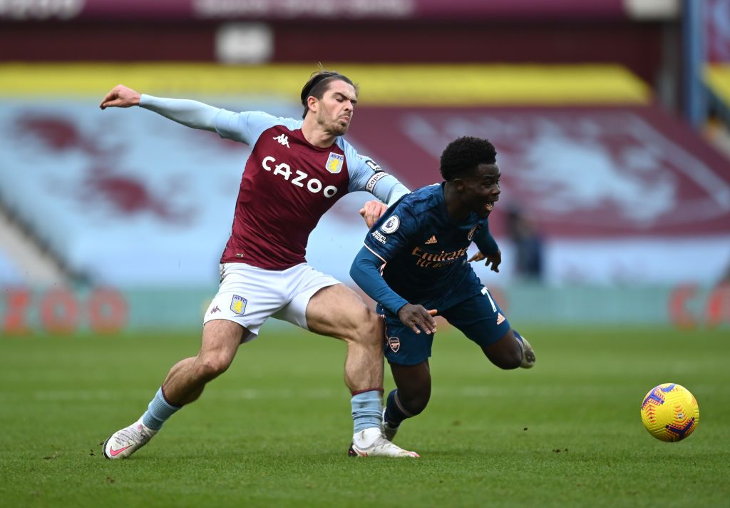 Aston Villa BIRMINGHAM, ENGLAND - FEBRUARY 06: Bukayo Saka of Arsenal is tackled by Jack Grealish of Aston Villa during the Premier League match between Aston Villa and Arsenal at Villa Park on February 06, 2021 in Birmingham, England. Sporting stadiums around the UK remain under strict restrictions due to the Coronavirus Pandemic as Government social distancing laws prohibit fans inside venues resulting in games being played behind closed doors. (Photo by Shaun Botterill/Getty Images)
