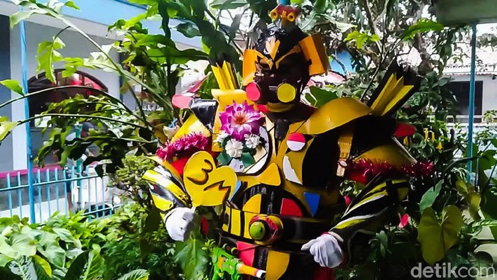 Warga Kampung Bewak, RT 3 RW 3, Desa Jayagiri, Kecamatan Lembang, Kabupaten Bandung Barat, dihebohkan dengan kemunculan karakter robot transformer berwarna kuning. Usut punya usut, karakter robot tersebut merupakan upaya kampanye protokol kesehatan untuk mencegah penyebaran COVID-19 terutama di kawasan Lembang.