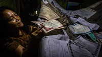 Seorang warga mengeringkan sejumlah dokumen berharga milik keluarganya yang basah terendam banjir di Kelurahan Tanjung Mas, Semarang, Jawa Tengah.