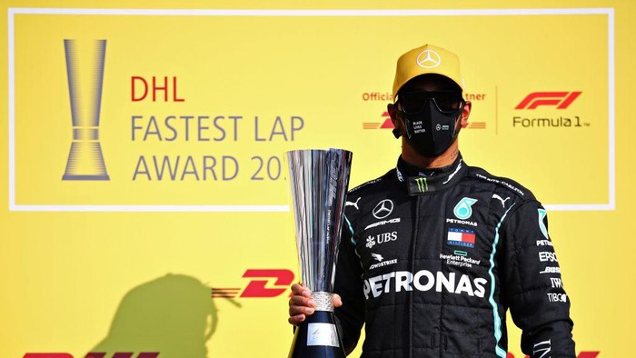 ABU DHABI, UNITED ARAB EMIRATES - DECEMBER 13: Lewis Hamilton of Great Britain and Mercedes GP is presented with the DHL Fastest Lap Award prior to the F1 Grand Prix of Abu Dhabi at Yas Marina Circuit on December 13, 2020 in Abu Dhabi, United Arab Emirates. (Photo by Bryn Lennon/Getty Images)