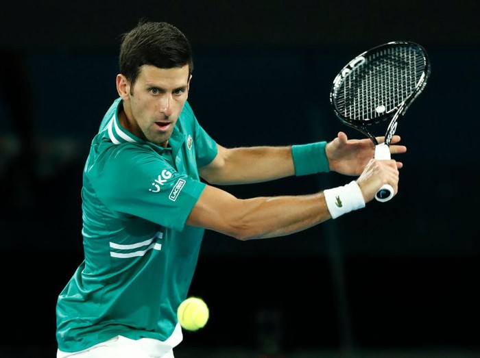MELBOURNE, AUSTRALIA - FEBRUARY 08: Novak Djokovic of Serbia plays a backhand in his Mens Singles first round match against Jeremy Chardy of France during day one of the 2021 Australian Open at Melbourne Park on February 08, 2021 in Melbourne, Australia. (Photo by Darrian Traynor/Getty Images)