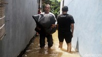 Warga pun tampak menyelamatkan barang-barang berharga mereka agar tak rusak akibat terendam banjir.