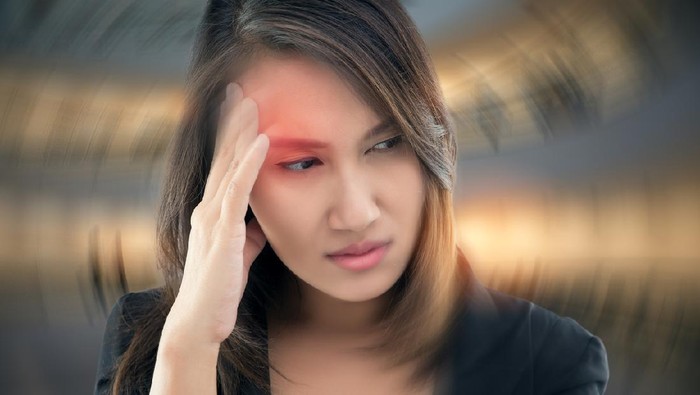 Working woman has Headache Against gray background, Benign Paroxysmal Positional Vertigo: BPPV, Concept with Sickness and Healthcare.