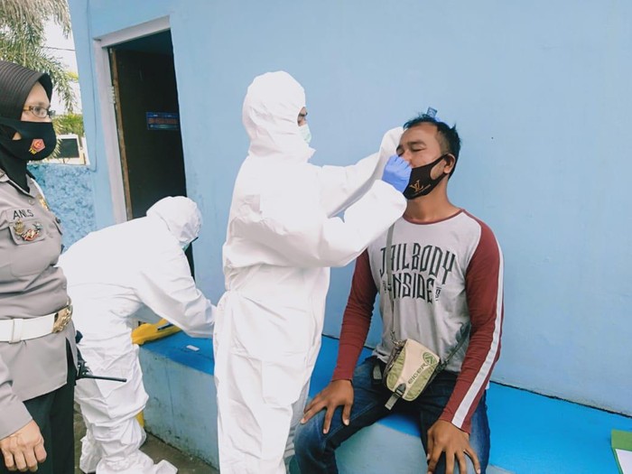Petugas kesehatan melakukan rapid antigen kepada warga di Pos Lantas Tangguh, Kabupaten Bandung.