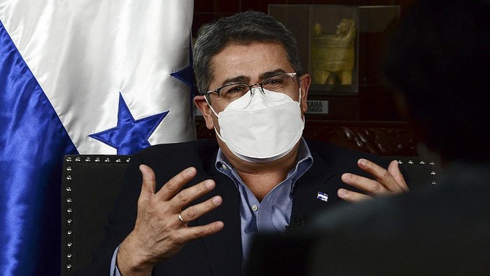Honduras President Juan Orlando Hernandez gestures during an interview with AFP at the presidential palace in Tegucigalpa on January 29, 2021. (Photo by ORLANDO SIERRA / AFP)