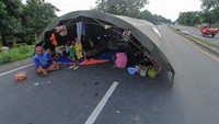 Pengungsi korban banjir mendirikan tenda darurat di jalan raya Pantura desa Jumbleng, Losarang, Indramayu, Jawa Barat, Selasa (9/2/2021). ANTARA FOTO/Dedhez Anggara.