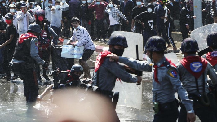 Demonstrators display three-fingered salute, a symbol of resistance at an intersection in Yangon, Myanmar Wednesday, Feb. 10, 2021. Protesters continued to gather Wednesday morning in Yangon breaching Myanmar's new military rulers' decrees that effectively banned peaceful public protests in the country's two biggest cities. (AP Photo)