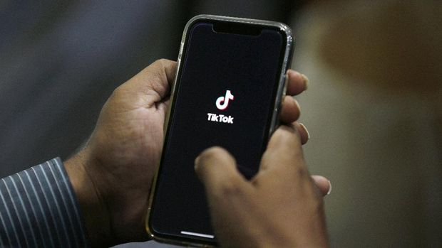 FILE - In this July 21, 2020 file photo, a man opens social media app 'TikTok' on his cell phone, in Islamabad, Pakistan. President Donald Trump said Saturday, Sept. 19, 2020 he’s given his “blessing” to a proposed deal between Oracle and Walmart for the U.S. operations of TikTok, the Chinese-owned app he’s targeted for national security and data privacy concerns. (AP Photo/Anjum Naveed, File)