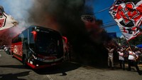 Salah satu bus melawati kerumunan para pedukung club Sao Paulo di Brasil. Alexandre Schneider / Getty Images
