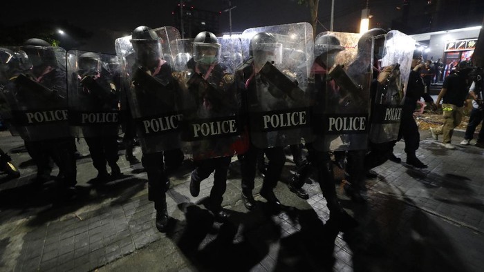 Hundreds of pro-democracy protesters march demanding the release of pro-democracy activists in Bangkok, Thailand, Wednesday, Feb. 10, 2021. Protesters demanded the government to step down, the constitution to be amended to make it more democratic and the monarchy be more accountable. (AP Photo/Sakchai Lalit)