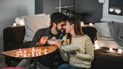 Young couple is in having a romantic dinner at home