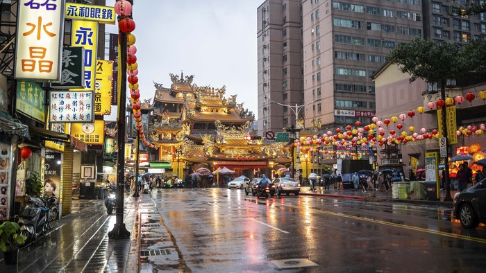 Taipei city street on rainy day at dusk with building exterior around