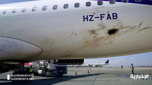 In this frame grab from video, Saudi state television shows an airplane damaged in an attack by Yemen's Houthi rebels at an airport near Abha, Saudi Arabia, Wednesday, Feb. 10, 2021. Yemen's Houthi rebels targeted the airport in southwestern Saudi Arabia, causing a civilian plane on the tarmac to catch fire, the kingdom's state television reported, an attack that threatens to escalate Yemen's grinding war. Authorities initially suspected the attack was carried out by a drone. (Saudi state television via AP)