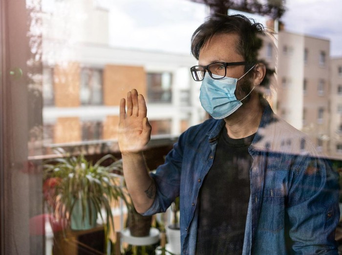1221432235 Man in isolation at home for virus outbreak