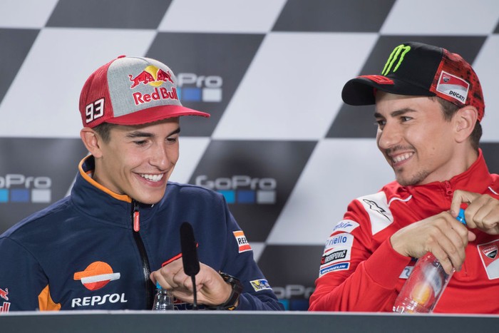 NORTHAMPTON, ENGLAND - AUGUST 23:  Jorge Lorenzo of Spain and Ducati Team and Marc Marquez of Spain and Repsol Honda Team (L) smile during the press conference pre-event during the MotoGp Of Great Britain - Previews at Silverstone Circuit on August 23, 2018 in Northampton, England.  (Photo by Mirco Lazzari gp/Getty Images)