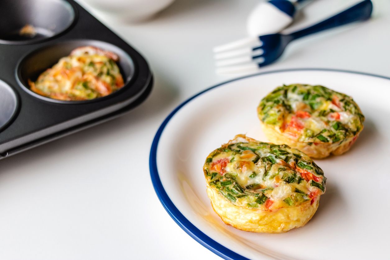 Healthy breakfast egg muffins with cheese, tomato and green veggetable, easy and healthy food concept