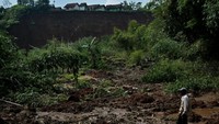 Warga melihat area persawahan yang tertimbun tanah longsor di Desa Karyamekar, Cilawu, Kabupaten Garut, Jawa Barat, Minggu (14/2/2021).