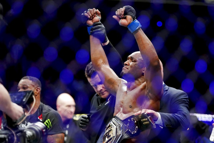 FILE - In this March 2, 2019, file photo, Kamaru Usman celebrates after his win against Tyron Woodley in a welterweight mixed martial arts title fight at UFC 235 in Las Vegas. Usman and Gilbert Burns were teammates only a year ago, and their children were fast friends. After Usmans split from their gym and Burns impressive rise in the welterweight division, theyll meet for Usmans title belt at UFC 258 this weekend. (AP Photo/John Locher, File)