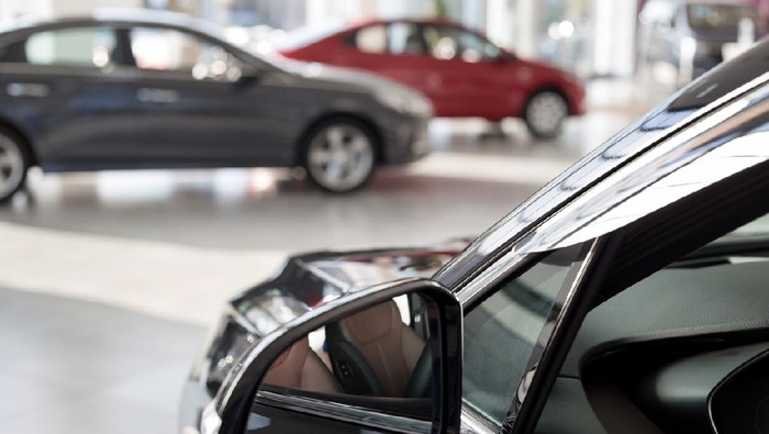 New cars at dealer showroom. Themed blur background with bokeh effect. Car auto dealership. Prestigious vehicles.