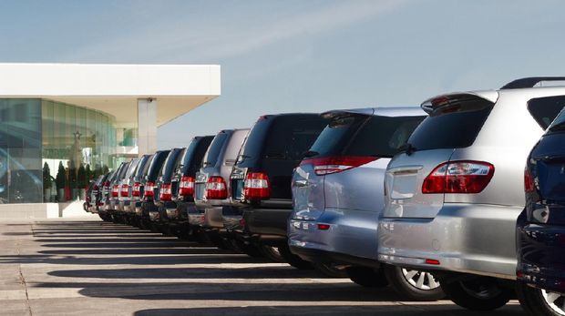 New cars at dealer showroom. Themed blur background with bokeh effect. Car auto dealership. Prestigious vehicles.