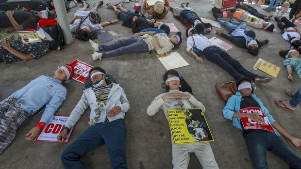 Demonstrators express their life under a military government with eyes blindfolded and dead during a protest against the military coup in Yangon, Myanmar Tuesday, Feb. 16, 2021. Security forces in Myanmar pointed guns toward anti-coup protesters and attacked them with sticks Monday, seeking to quell the large-scale demonstrations calling for the military junta that seized power this month to reinstate the elected government. (AP Photo)