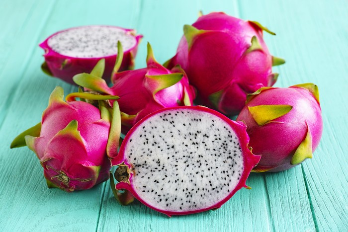 Buah Naga White Dragon Fruit on an old turquoise wooden table.