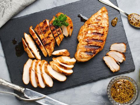 Ilustrasi Dada Ayam Grilled chicken fillets on slate plate. Gray concrete background