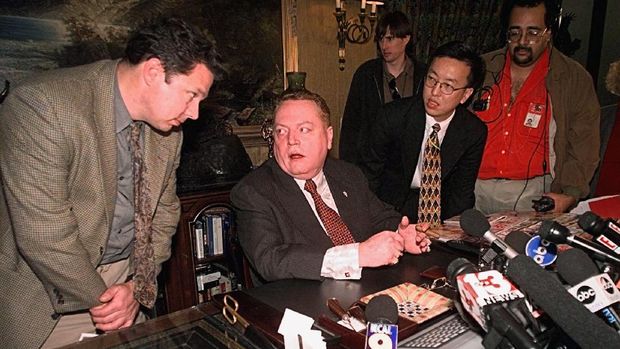 Larry Flynt, Hustler magazine publisher, is surrounded by reporters Friday, Dec. 18, 1998 Los Angeles.  Flynt claimed Friday he has gathered evidence showing that Rep. Bob Livingston has had possibly a dozen extramarital affairs within the past 10 years.   Flynt said Livingston's admission of adultery was prompted by Flynt's discoveries. (AP Photo/Kevork Djansezian)