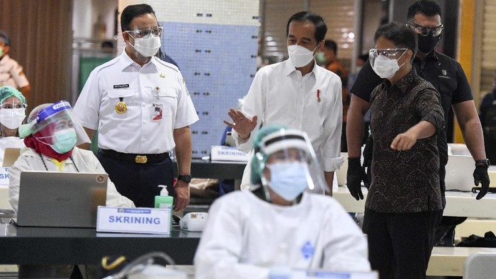 Jokowi dan Anies Pantau Vaksinasi Pedagang Tanah Abang Presiden Joko Widodo (tengah) didampingi Menteri Kesehatan Budi Gunadi Sadikin (kanan) dan Gubernur DKI Jakarta Anies Baswedan meninjau vaksinasi COVID-19 massal bagi pedagang di Pasar Tanah Abang Blok A, Jakarta, Rabu (17/2/2021). Vaksinasi COVID-19 tahap kedua yang diberikan untuk pekerja publik dan lansia itu dimulai dari pedagang Pasar Tanah Abang. ANTARA FOTO/Hafidz Mubarak A/wsj.