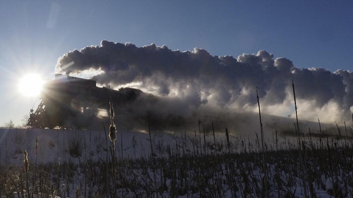 A Soviet era steam locomotive pulls a retro train from the city of Sortavala about 200 km (125 miles) north of St.Petersburg, Russia, Wednesday, Feb. 17, 2021. The steam-powered retro train runs daily in Karelia, a Russian region on the border with Finland, taking tourists to the Ruskeala natural park from the city of Sortavala. (AP Photo/Dmitri Lovetsky)