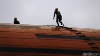 Karena beresiko tinggi, para pekerja itu dibekali alat-alat pengaman seperti tali dan helm.