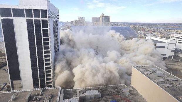 The former Trump Plaza Hotel & Casino implodes in Atlantic City, N.J., Wednesday, Feb 17, 2021. The former Trump Plaza casino was imploded after falling into such disrepair that chunks of the building began peeling off and crashing to the ground. (Edward Lea/The Press of Atlantic City via AP)