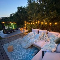 Keduanya juga membangun teras di luar bus yang dibangun dari lantai kayu, sofa, karpet serta meja kayu dan beberapa bohlam. Foto: Instagram/@doubledeckerhome