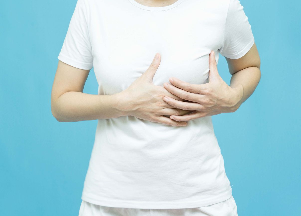 World Breast Cancer Day Concept,health care - woman wore  white t-shirt and holding her chest ,women's breast tumor illness
