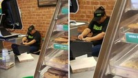Karyawan yang mencongkel kakinya di belakang konter makanan.