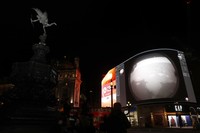 Images from Nasa are streamed live showing the landing of NASAs Perseverance on Mars, shown on Piccadilly Lights in central London, Thursday Feb. 18, 2021.  The Mars rover landing mission begins its search for traces of life after the successful landing, to explore and collect samples for future return to Earth. Eros statue top left. (AP Photo/Alastair Grant)