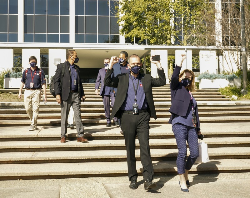 Thomas Zurbuchen, NASA Associate Administrator Science Mission Directorate, raises his arms, center, with Lori Glaze, Director of NASA's Science Mission Directorate's Planetary Science Division, right, as they walk with members of NASA's Perseverance rover team after receiving confirmation the spacecraft successfully touched down on Mars, Thursday, Feb. 18, 2021, at NASA's Jet Propulsion Laboratory in Pasadena, Calif. (AP Photo/Damian Dovarganes)