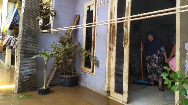 Warga Cipinang Melayu mulai membersihkan rumah dari sisa banjir, MInggu (21/2/2021).