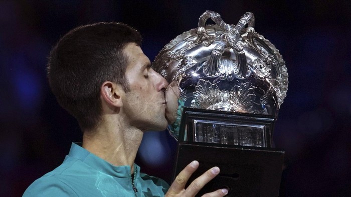 Serbias Novak Djokovic kisses the Norman Brookes Challenge Cup after defeating Russias Daniil Medvedev in the mens singles final at the Australian Open tennis championship in Melbourne, Australia, Sunday, Feb. 21, 2021.(AP Photo/Mark Dadswell)