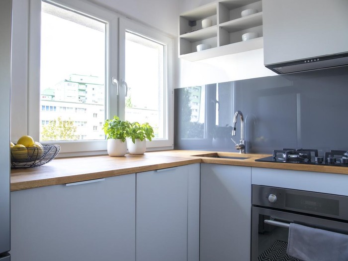 Desain dapur di rumah minimalis small kitchen in a pool guest house with appliances and cabinets and a counter and custom lighting