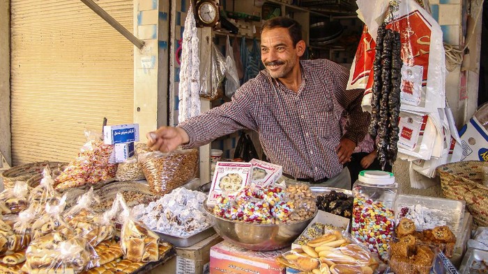 Vendor in small grocery store in Market in downtown Arbil northern Iraq