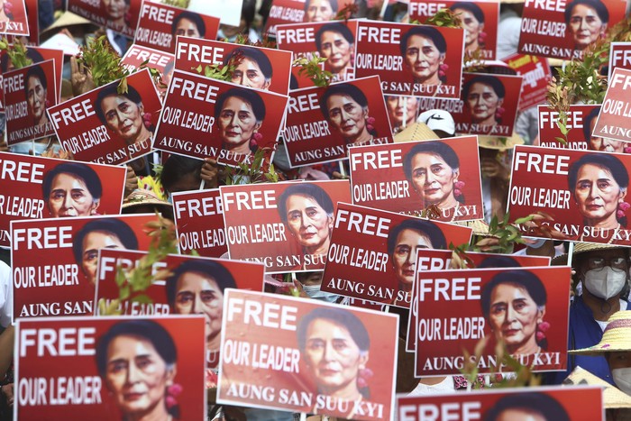 Protesters hold images of ousted leader Aung San Suu Kyi during an anti-coup protest in Mandalay, Myanmar, Sunday, Feb. 21, 2021. Police in Myanmar shot dead a few anti-coup protesters and injured several others on Saturday, as security forces increased pressure on popular revolt against the military takeover. (AP Photo)