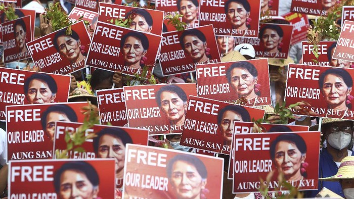 Protesters hold images of ousted leader Aung San Suu Kyi during an anti-coup protest in Mandalay, Myanmar, Sunday, Feb. 21, 2021. Police in Myanmar shot dead a few anti-coup protesters and injured several others on Saturday, as security forces increased pressure on popular revolt against the military takeover. (AP Photo)