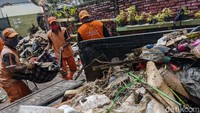 Petugas berjibaku membersihkan sampah.