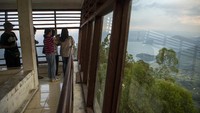 Wisawatan menikmati pemandangan Danau Toba dari atas menara pandang Tele di Turpuk Limbong, Harian, Kabupaten Samosir, Sumatera Utara, Minggu (21/2/2021).
