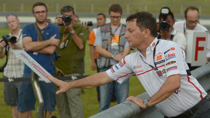 Fausto Gresini, team manager of San Carlo Honda Gresini pays his respects during a tribute to Italian rider Marco Simoncelli, who died during an accident at the 2011 Malaysian Grand Prix, in Sepang on October 18, 2012. The Malaysian grand prix begins October 19 to 21. AFP PHOTO / MOHD RASFAN (Photo by MOHD RASFAN / AFP)