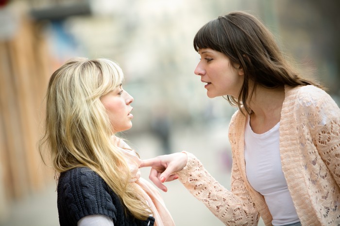 Ilustrasi Melabrak Pelakor Two women talking to each other and arguing.