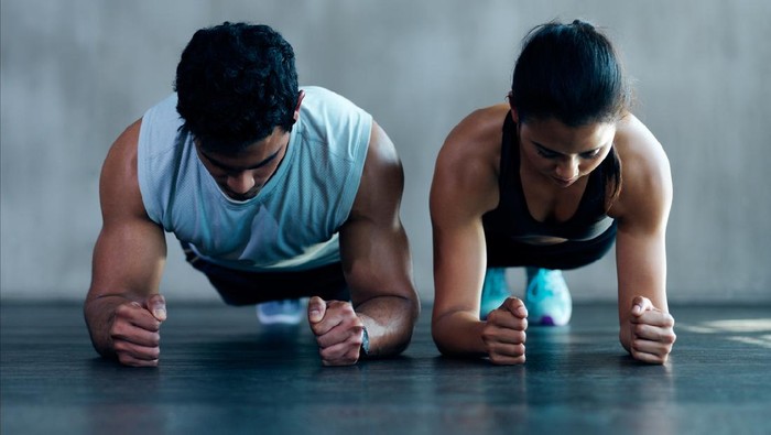Shot of an attractive young couple working out together at the gym