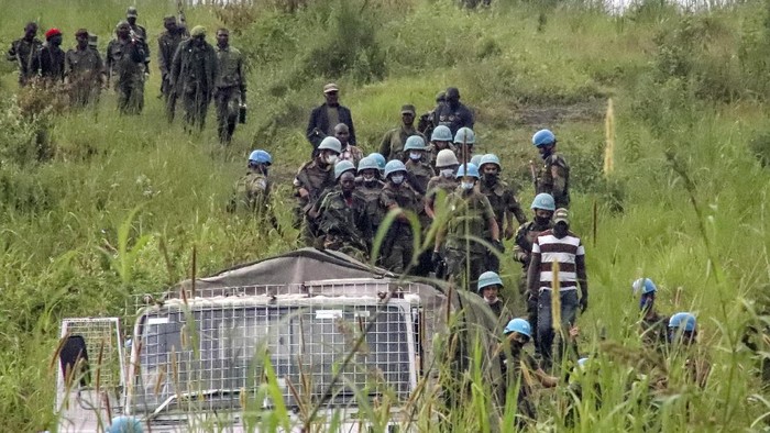 Rombongan PBB Diserang, Dubes Italia untuk Kongo Tewas United Nations peacekeepers and Congolese forces guard an area leading to where bodies were found near to where a U.N. convoy was attacked and the Italian ambassador to Congo killed, in Nyiragongo, North Kivu province, Congo Monday, Feb. 22, 2021. The Italian ambassador to Congo Luca Attanasio, an Italian Carabineri police officer and their Congolese driver were killed Monday in an attack on a U.N. convoy in an area that is home to myriad rebel groups, the Foreign Ministry and local people said. (AP Photo/Justin Kabumba)