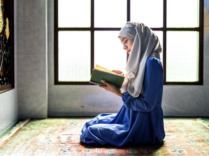 Muslim woman reading from the quran